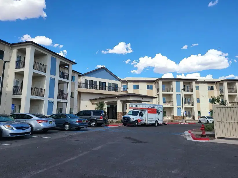 Moving van parked by entryway to the partially completed Pedreña Senior Apartments.